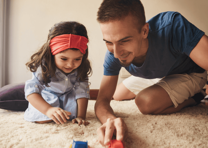 Picture of girl and male nanny in los angeles playing with cars