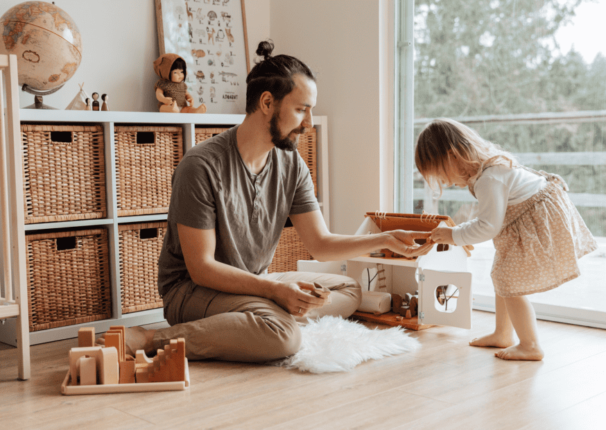 male-nanny-playing-with-girl-in-room